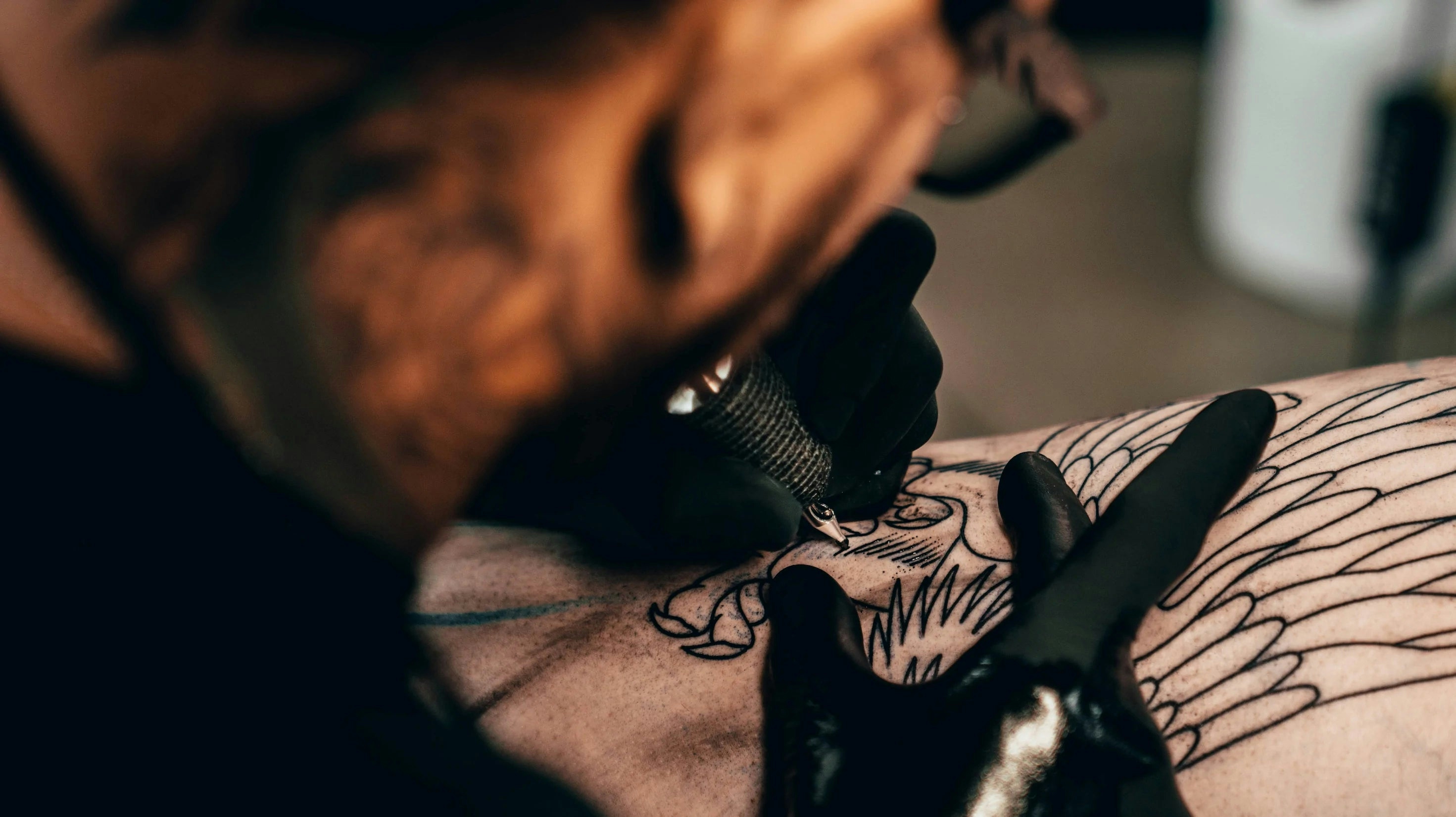 tattoo artist fixing tattoo cracking